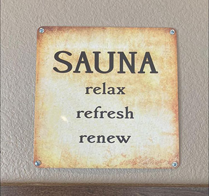 Picture of a sign that says Sauna, relax, refrest, renew